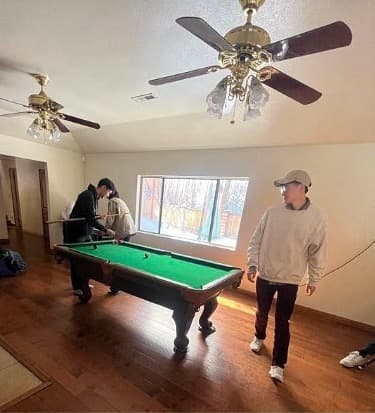 techie members playing pool during a retreat